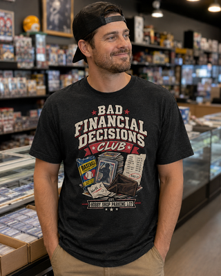 A man wearing a black graphic t-shirt that reads 'BAD FINANCIAL DECISIONS CLUB' with a retro illustration, standing in a retail store aisle.